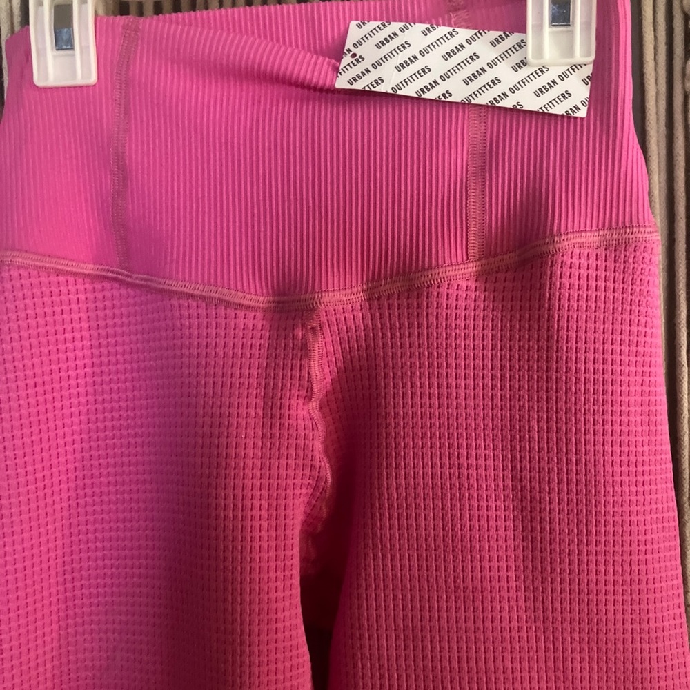 Urban Outfitters pink yoga pants. SizeM/L.  NWT, never worn. Cute slit detail.